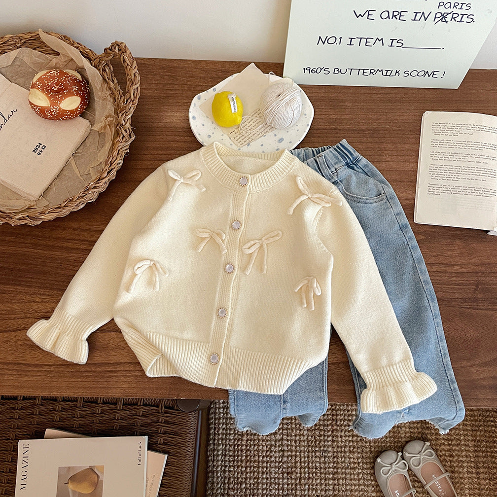 Abrigo de punto con lazo para niña