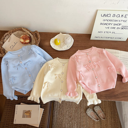 Abrigo de punto con lazo para niña