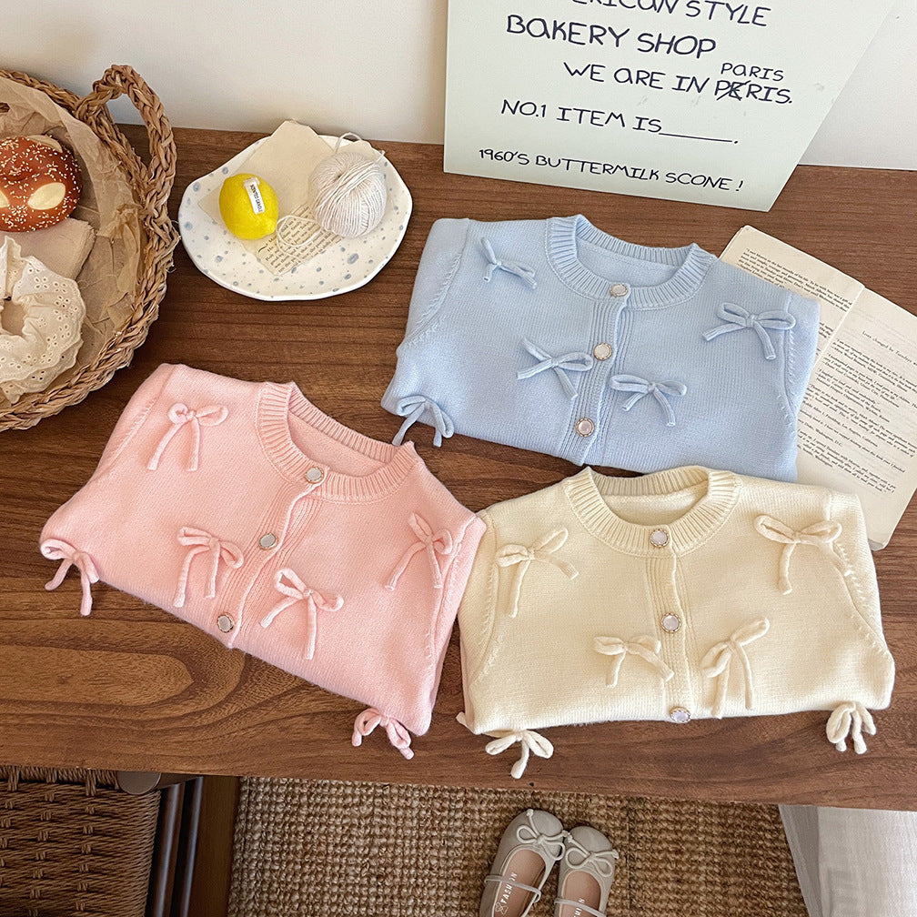 Abrigo de punto con lazo para niña