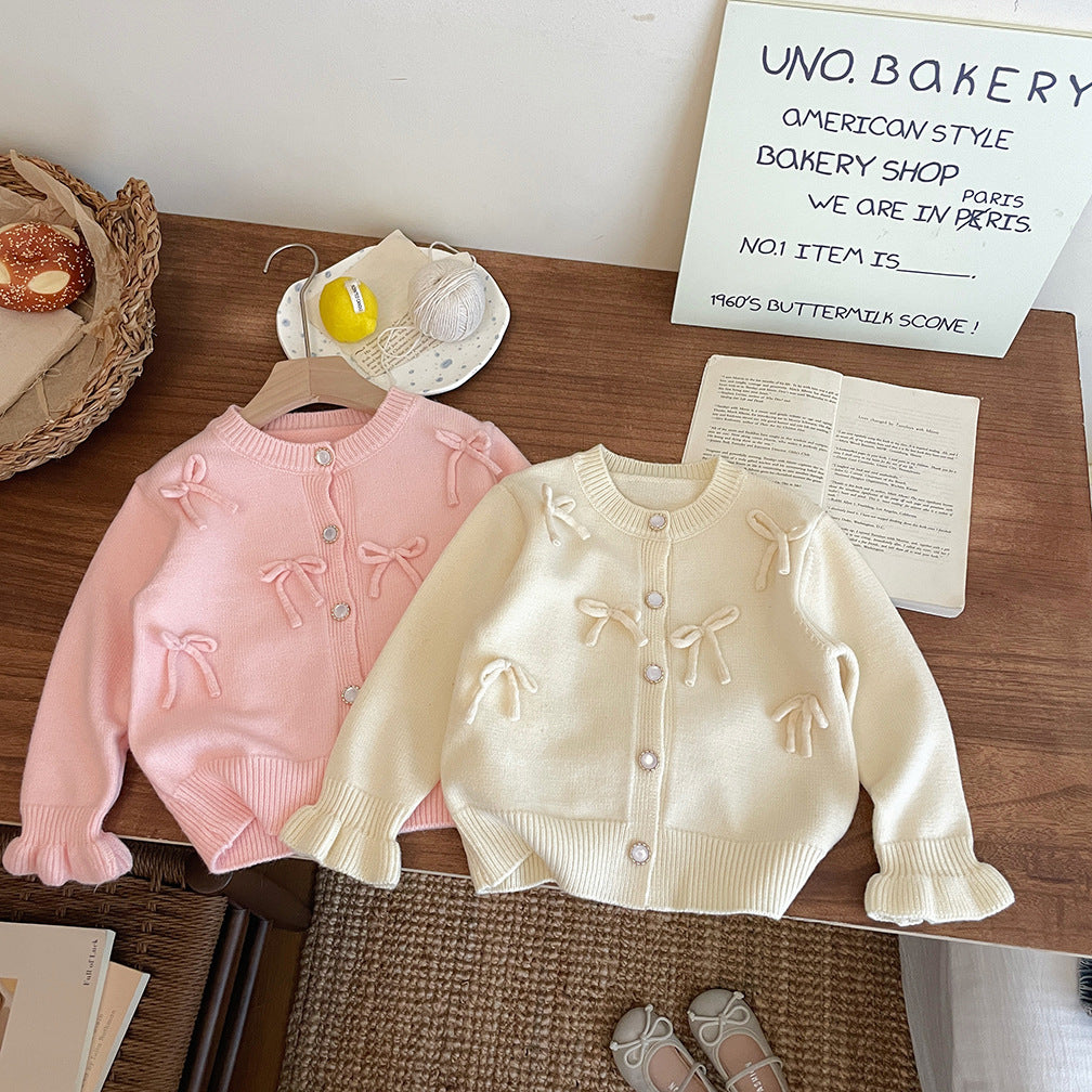 Abrigo de punto con lazo para niña